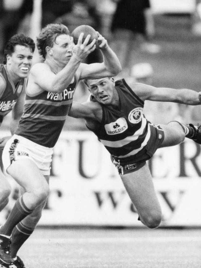 Eagles player Glenn Freeborn marks despite the efforts of Simon Luhrs during a 1994 SANFL match at Woodville Oval.