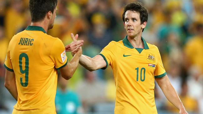 SYDNEY, AUSTRALIA - JANUARY 13: Tomi Juric of the Socceroos is congratulated by team mate Robbie Kruse after scoring a goal during the 2015 Asian Cup match between Oman and Australia at ANZ Stadium on January 13, 2015 in Sydney, Australia. (Photo by Cameron Spencer/Getty Images)