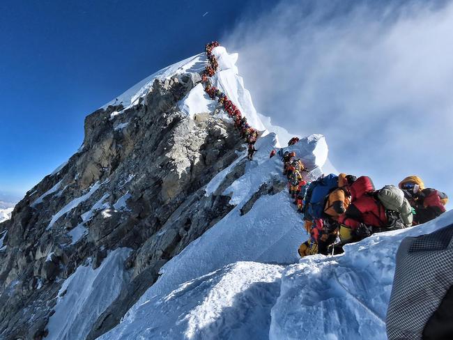 Climbing queue ... mountaineers await their chance during a limited window of clear weather to reach the top of Mt Everest. Picture: @nimsdai Project Possible / AFP