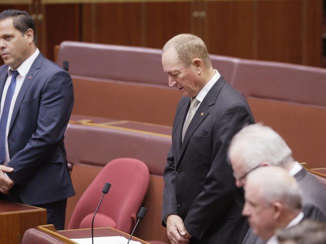 Australian senator Fraser Anning, centre, bows his head in the chamber at the start of the senate session yesterday. Picture: AP