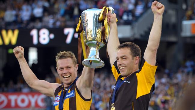 Hawthorn captain Sam Mitchell and coach Alastair Clarkson hold aloft the 2008 premiership cup.