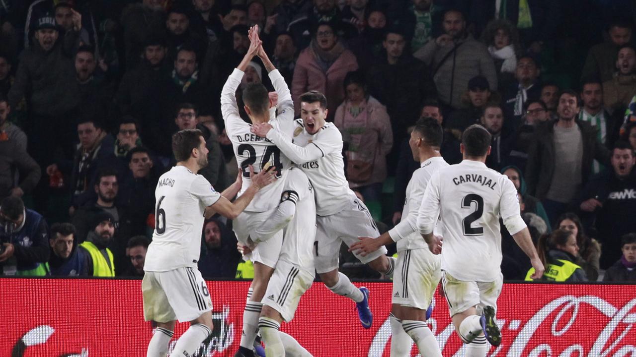 Real Madrid's Dani Ceballos, top, celebrates with teammates