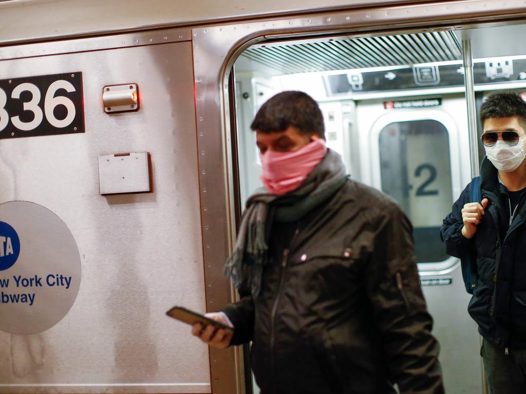 Men wear face masks as they ride on the subway in New York City. Picture: Kena Betancur / AFP