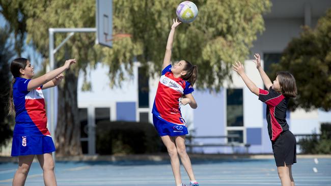 Jakayla Milera, 11, Leilani Milera, 10, and Paige Vlotman, 9, at Northfield Primary School have a game. Picture: Naomi Jellicoe