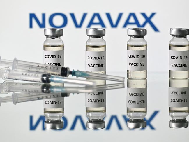 (FILES) In this file illustration photo taken on November 17, 2020 vials with Covid-19 Vaccine stickers attached and syringes with the logo of US biotech company Novavax, on November 17, 2020. - Novavax said February 10, 2022 its Covid vaccine was 82 percent effective among adolescents during the period when the Delta variant was dominant, and the US biotech now plans to submit for regulatory approval in this age group. (Photo by JUSTIN TALLIS / AFP)