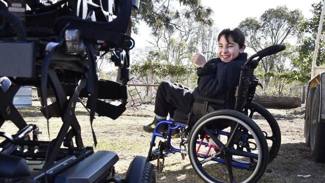 A new wheelchair has finally arrived for nine-year-old, Angus Hopkins. The long awaited delivery on Sunday will be a life changer for the boy from Nobby. An excited Angus watches on as the adjustments are made to the wheelchair. June 2019. Picture: Bev Lacey