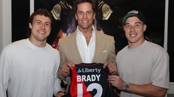 Essendon's Andy McGrath and Zac Merrett with NFL legend Tom Brady