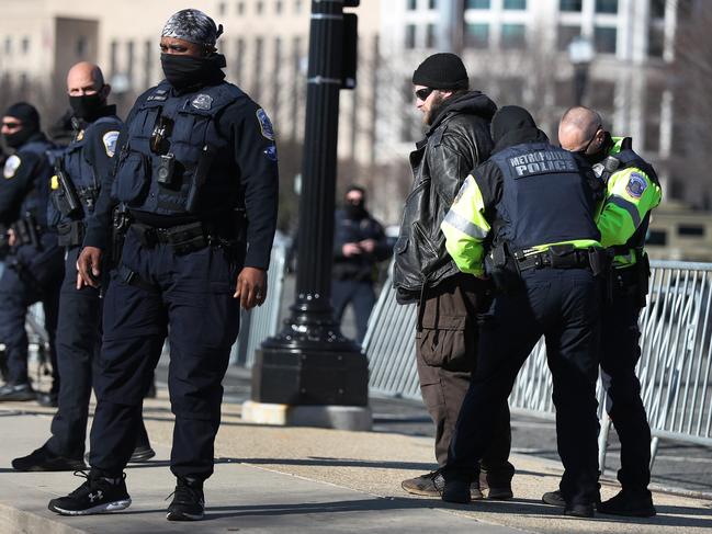 Members of the Metropolitan Police Department of the District of Columbia detain a person for questioning a day after a pro-Trump mob broke into the U.S. Capitol building. Picture: Getty