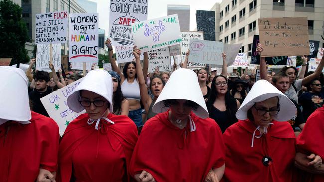 Abortion rights activists, dressed in an outfits from The Handmaid's Tale, lead protesters during a march in Denver, Colorado. Picture: AFP