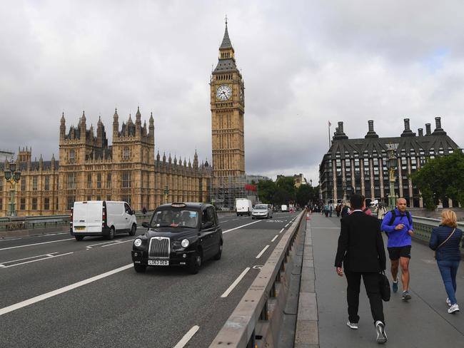 Morning commuters cross Westminster Bridge with Big Ben and the Houses of Parliament in the background of central London on June 9, 2017 after snap election results show a hung parliament with Labour gains and the loss of the Conservative majority. Picture: AFP / Paul Ellis.