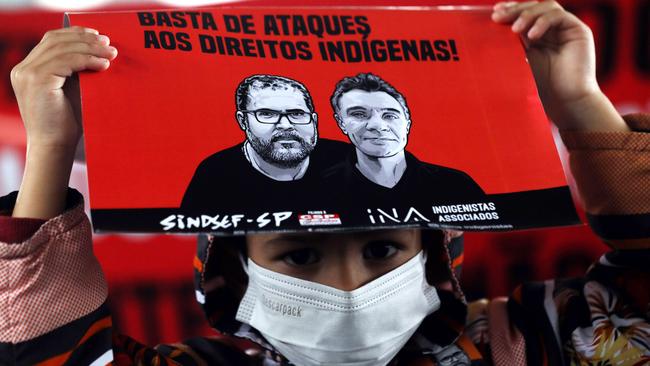 A young demonstrator holds a sign during a protest organized by Guarani indigenous members and environmental activists to demand justice for assassinated British journalist Dom Phillips and indigenous activist Bruno Pereira on June 18, 2022 in Sao Paulo, Brazil. After 11 days of search, police discovered human remains after a suspect confessed to the killing of Phillips and Pereira who went missing on June 05 in the Javari Valley, in the Amazon rainforest, near the border with Peru. Federal Police said on June 17 they have identified the remains of Phillips. (Photo by Rodrigo Paiva/Getty Images)