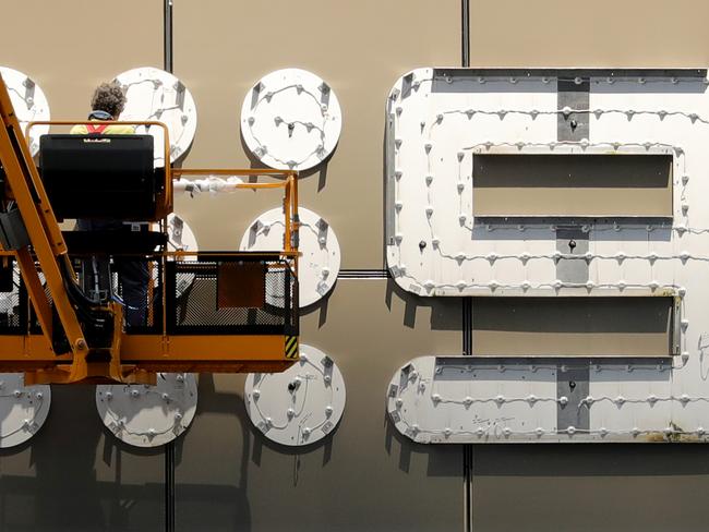 29/11/2018: A worker carries out maintenance repairs on the Channel 9 office sign, in the Docklands, Melbourne. Stuart McEvoy/The Australian.