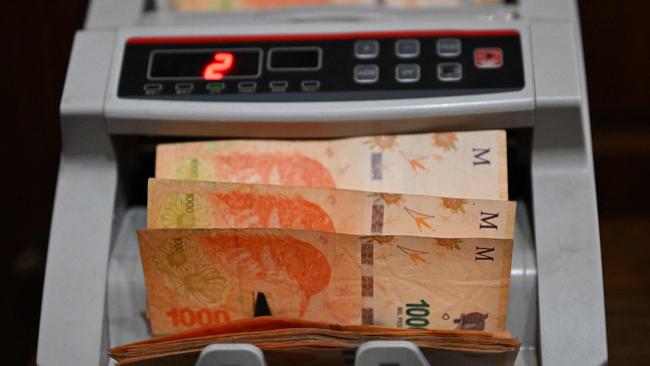 Argentine pesos bills are counted with a bill-counting machine in Buenos Aires. Picture: AFP