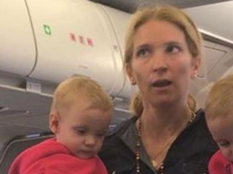 woman with twins sobbing american airlines