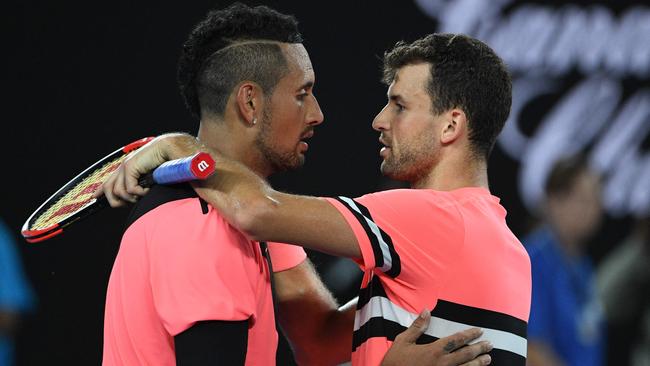 Nick Kyrgios embraces Grigor Dimitrov after the match. Picture: AFP PHOTO