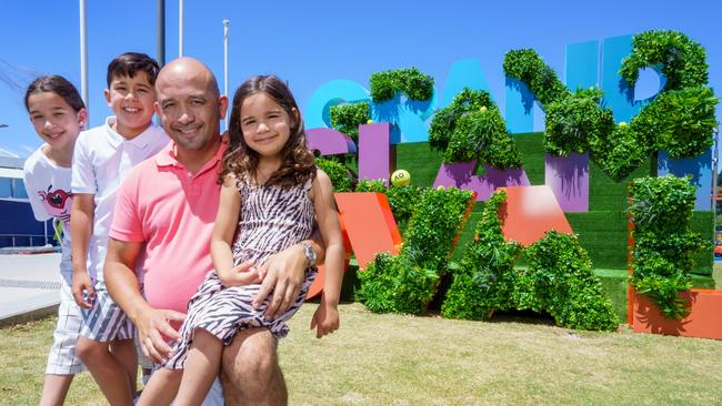 Adam D'Sylva and his three kids, Ava (11), Javier (9), and Olivia (5) at Melbourne Park. Picture: Jay Town.