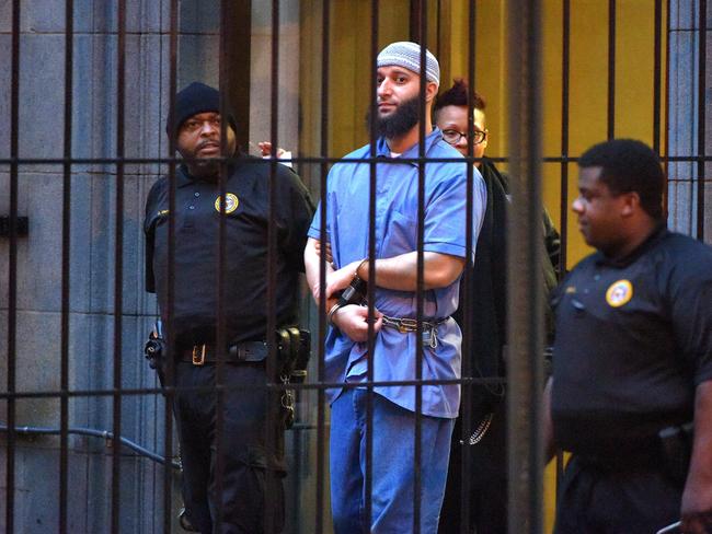 Officials escort "Serial" podcast subject Adnan Syed from the courthouse following the completion of the first day of hearings for a retrial in Baltimore in February, 2016. Picture: Karl Merton Ferron