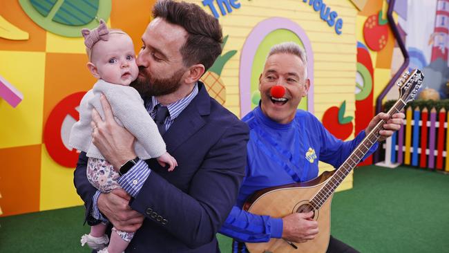 Luke Field cuddles four-month-old daughter Frankie, while uncle Anthony Field continues The Wiggles’ longstanding support of Red Nose Day. Picture: Sam Ruttyn