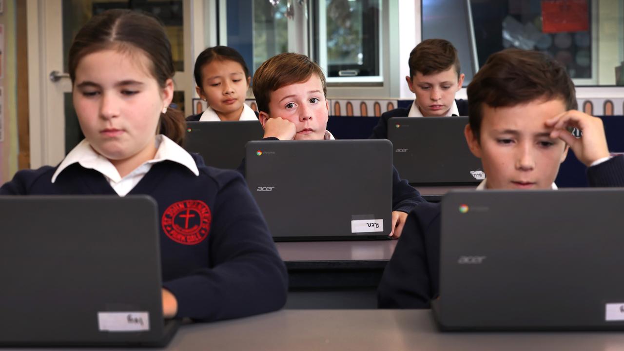 Ren (centre) sits a practice NAPLAN test with fellow year 5 students Ivy and Leroy, (front) Thao 10 and Billy 10 (back) on laptop computers. Picture: David Caird