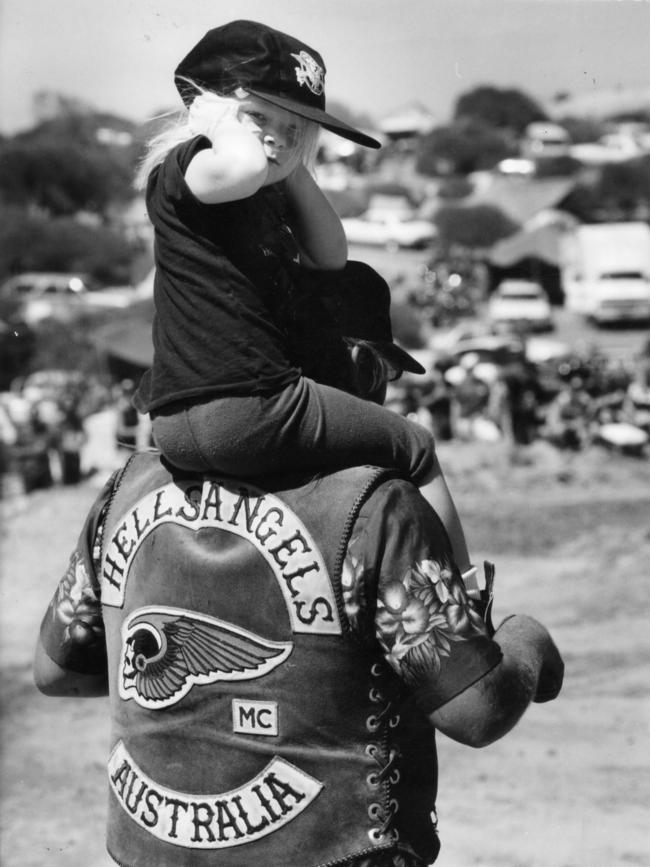 The bikes were just too loud for young girl Amy Savage, 3, sitting on her dad Paul's shoulders at Ponde rock music festival, held by the Hell's Angels Motorcycle Club in Ponde near Mannum, SA, 19 Feb 1995.