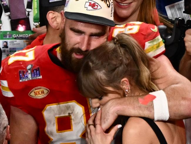 (FILES) US singer-songwriter Taylor Swift and Kansas City Chiefs' tight end #87 Travis Kelce embrace after the Chiefs won Super Bowl LVIII against the San Francisco 49ers at Allegiant Stadium in Las Vegas, Nevada, February 11, 2024. Kelce is helping survivors of the shooting that marred the Kansas City Chiefs' Super Bowl victory parade, after his world-famous girlfriend Swift did the same, NBC news reported on February 17, 2024. The shooting on February 14 left one woman dead and 22 people injured â including two girls in the Reyes family. Kelce's Eighty-Seven Running foundation made two $50,000 donations to a GoFundMe raising money to support the Reyes family, a Kelce representative confirmed to NBC. (Photo by Patrick T. Fallon / AFP)