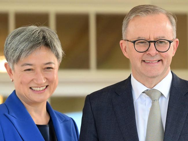 Australia's new Prime Minister Anthony Albanese (C) poses with his new cabinet ministers, Penny Wong (L) and Richard Marles after the oath taking ceremony at Government House in Canberra on May 23, 2022. (Photo by SAEED KHAN / AFP)