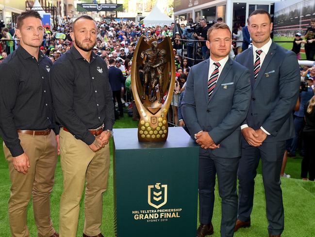 Canberra Raiders co-captains Josh Hodgson and Jarrod Croker along with Sydney Roosters co-captains Jake Friend and Boyd Cordner pose for a photograph with the Proven Summons trophy during the NRL Fan Fest event at Martin Place in Sydney, Thursday, October 3, 2019. (AAP Image/Dan Himbrechts) NO ARCHIVING