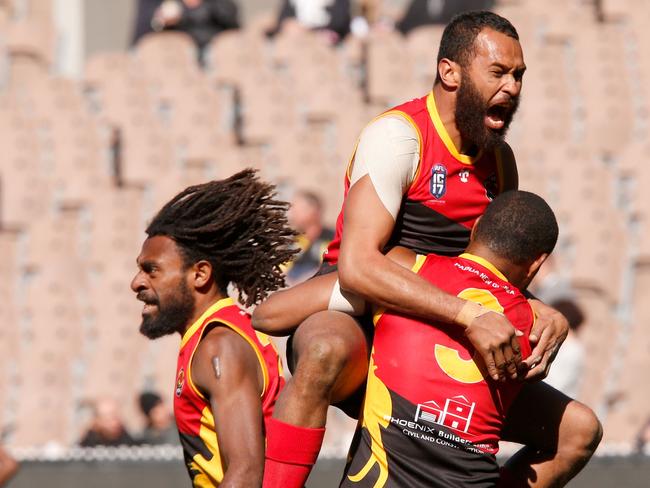 MELBOURNE, AUSTRALIA - AUGUST 19: Papua New Guinea celebrate after the 2017 AFL International Cup Mens Division 1 Grand Final match between New Zealand and Papua New Guinea at the Melbourne Cricket Ground on August 19, 2017, in Melbourne, Australia. (Photo by Darrian Traynor/AFL Media)