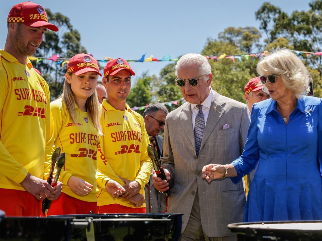 Britain's King Charles III (2nd R) and Queen Camilla (R) cook sausages at the BBQ station as they attend the Premier's Community BBQ in Sydney on October 22, 2024. (Photo by Brook Mitchell / POOL / AFP)