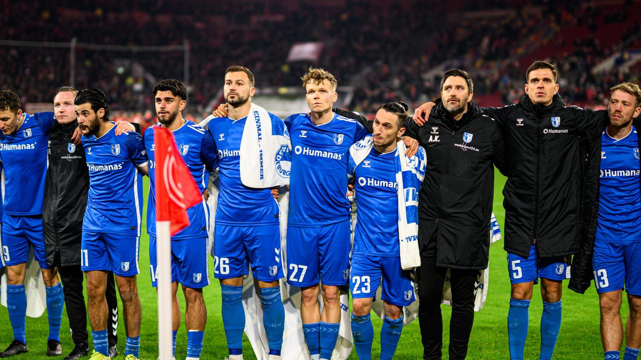 Magdeburg players stand together with their fans during the Second Bundesliga match. Picture: Frederic Scheidemann/Getty