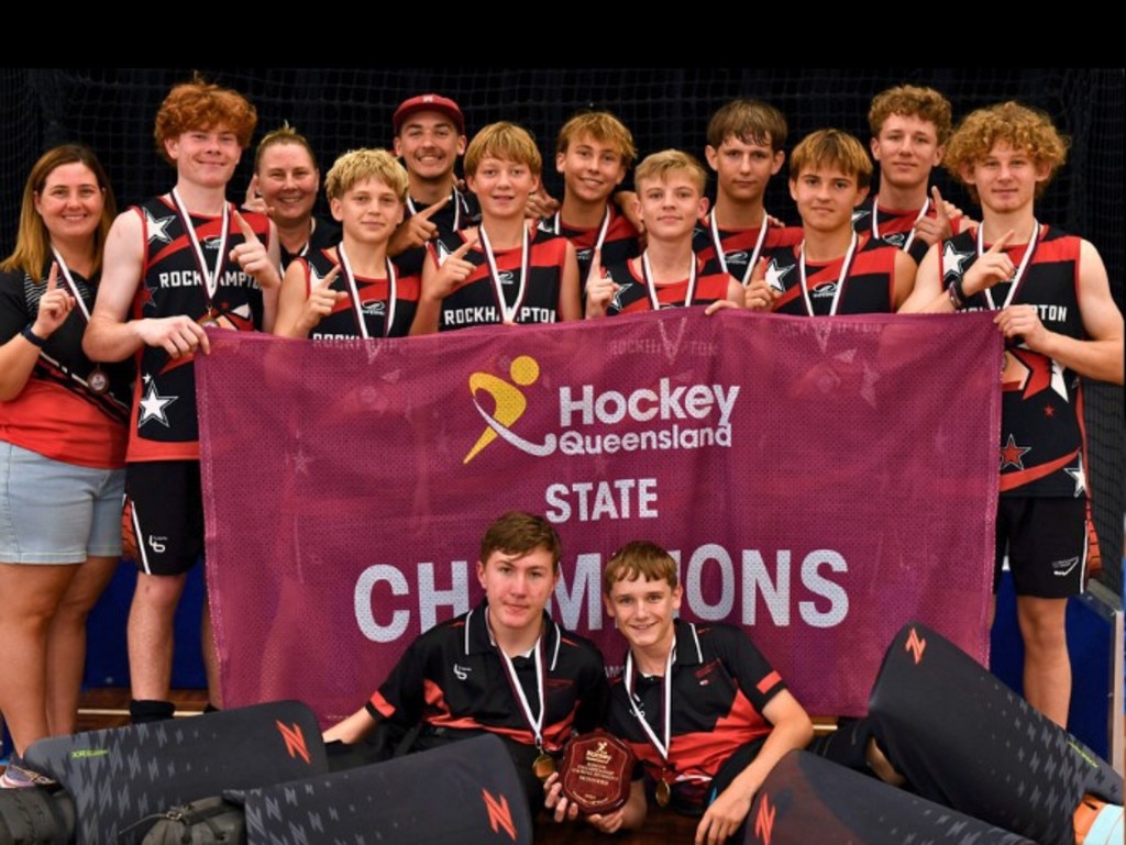 The Rockhampton under-16 players and coaching staff celebrate their win at the Queensland indoor hockey championships in Townsville.