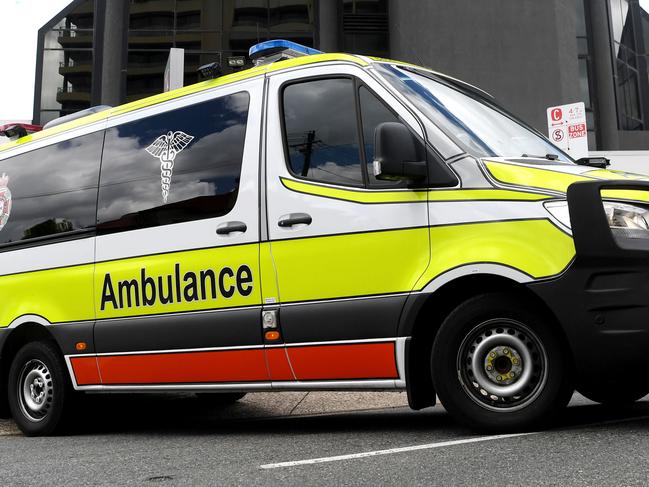 BRISBANE, AUSTRALIA - NewsWire Photos - JANUARY 13, 2021.An Ambulance leaves the Hotel Grand Chancellor in Spring Hill, Brisbane. Guests will be evacuated after six people linked to the building tested positive to the highly-contagious UK variant of the coronavirus.Picture: NCA NewsWire / Dan Peled