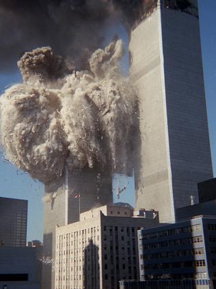 Smoke &amp; debris erupt from the south tower of the World Trade Centre.