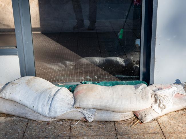 Sand bags placed in shop door ways in the eastern suburbs to stop water from flash floods. Picture: Thomas Lisson