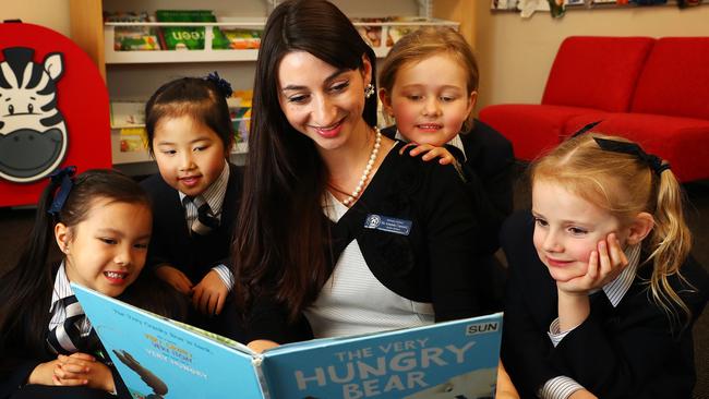 Meriden School teacher Amanda Caminiti in the school library with students. Picture: John Feder