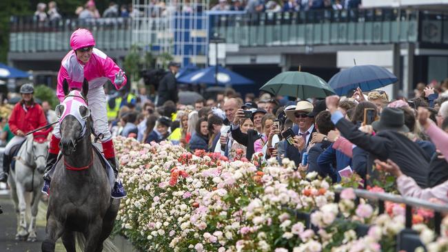 Jockey Craig Williams, aboard Star Missile, salutes the crowd on Oaks Day last year. Picture: Jay Town