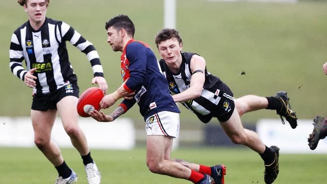 North Hobart's Jeffrey Fisher is tackled by Glenorchy's Cooper Meredith. Picture: ZAK SIMMONDS