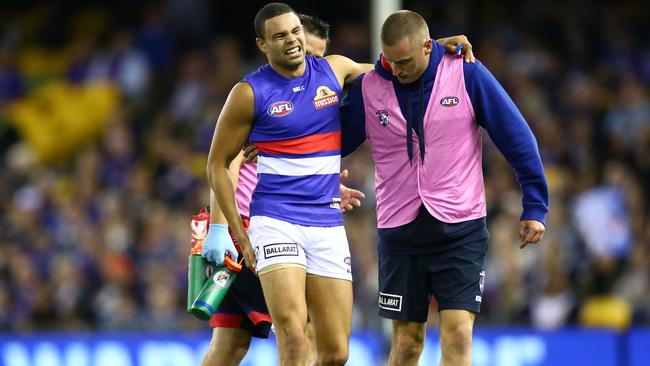 MELBOURNE, VICTORIA - APRIL 16: Jason Johannisen of the Bulldogs leaves the field injured during the round four AFL match between the Carlton Blues and the Western Bulldogs at Etihad Stadium on April 16, 2016 in Melbourne, Australia. (Photo by Scott Barbour/AFL Media/Getty Images)