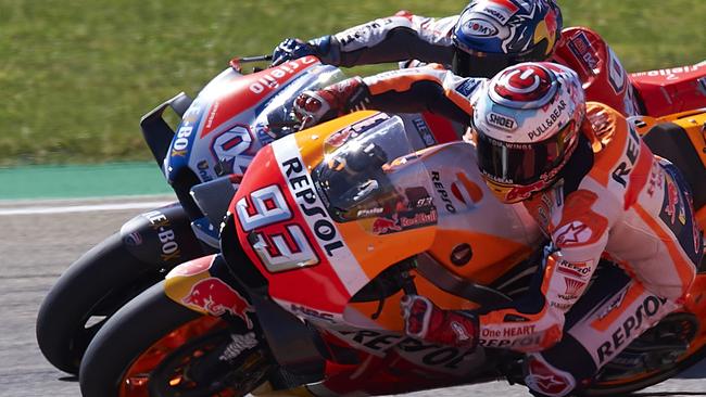 Spain's rider Marc Marquez of the Repsol Honda Team, front, steers his motorcycle followed by Italian rider Andrea Dovizioso of the Ducati Team at the MotoGP race during the Aragon Motorcycle Grand Prix at the Aragon Motorland racetrack in Alcaniz, Spain, Sunday, Sept. 23, 2018. (AP Photo/Jose Breton)