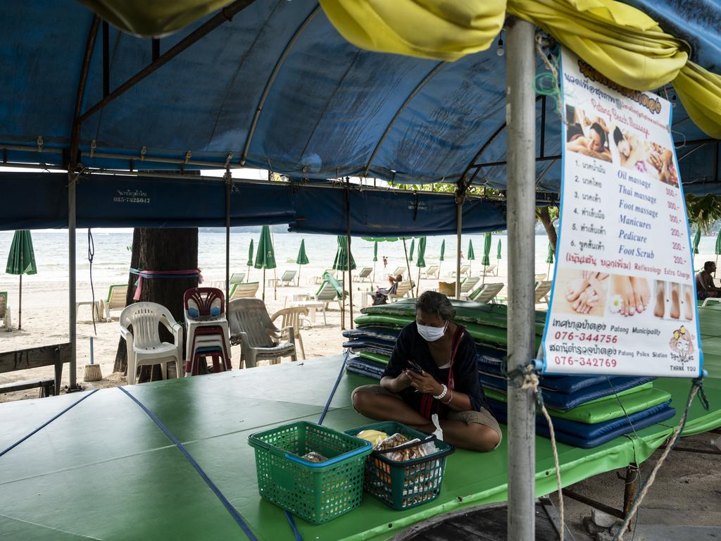 A masseuse hopes for customers on the street. Picture: Sirachai Arunrugstichai/Getty Images