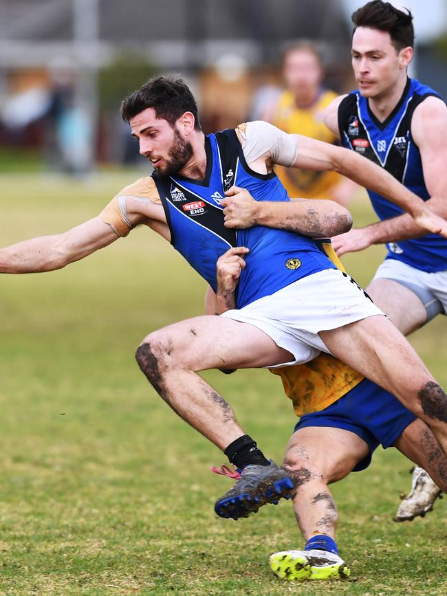 ...and gets him holding the ball. Picture: AAP/Mark Brake