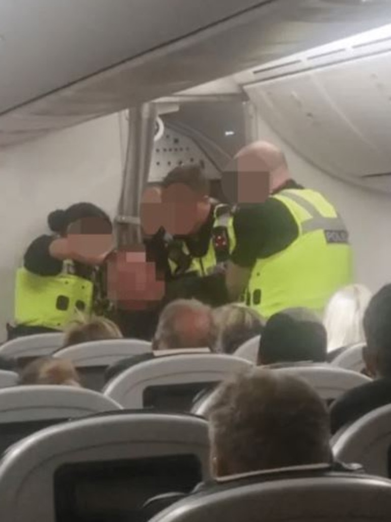 Passengers cheered when three police officers finally managed to detain the man. Picture: Supplied