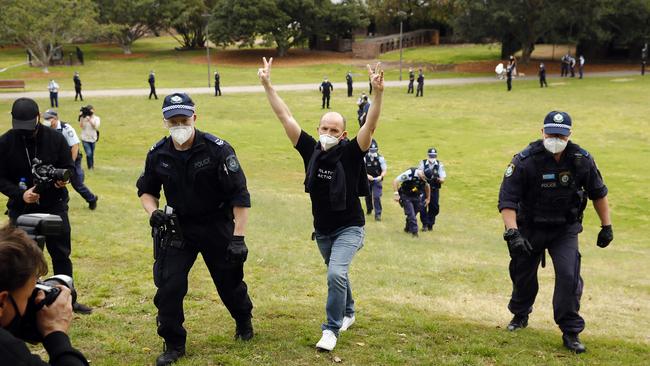 An anti-lockdown protester at Sydney Park is led away by police. Picture: Sam Ruttyn