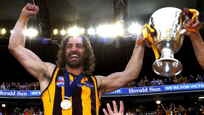 Matt Spangher holds up the premiership cup following the 2014 Grand Final.