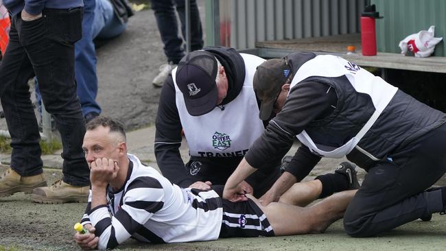 Brad Scalzo watches the action while getting a rub. Picture: Valeriu Campan