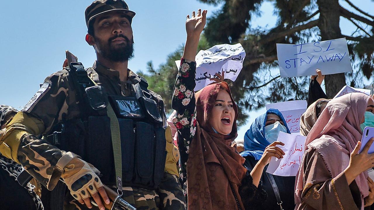 Afghan women shout slogans next to a Taliban fighter during an anti-Pakistan demonstration near the Pakistan embassy in Kabul on September 7. Picture: Hoshang Hashimi
