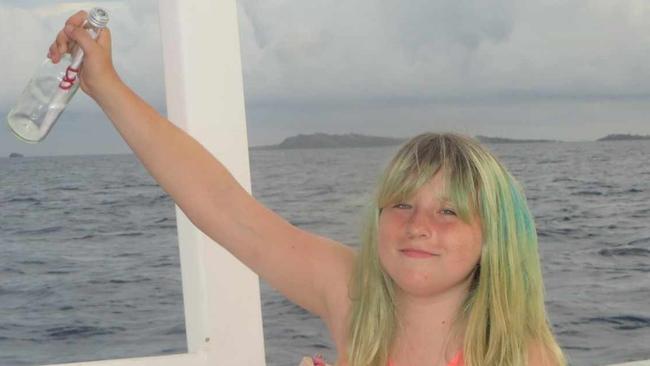 San Francisco Bay Area Savannah, then aged 11, photographed setting the message-in-a-bottle adrift on the final day of a family holiday at the Navini Island Resort in Fiji in 2016. The bottle was discovered washed ashore in Townsville, North Queensland, eight years later on Friday. Picture: Supplied