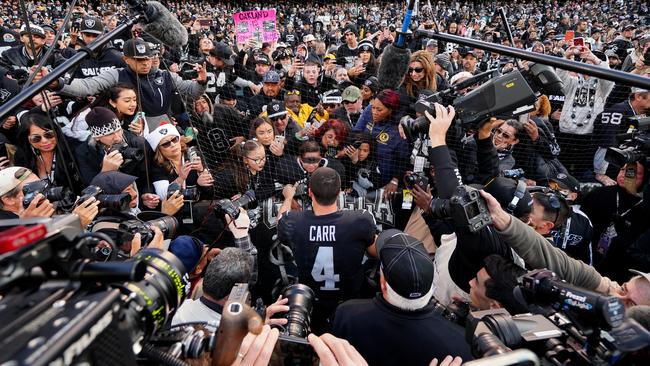 Fans mob Oakleigh Raiders player Derek Carr at Oakland Coliseum.