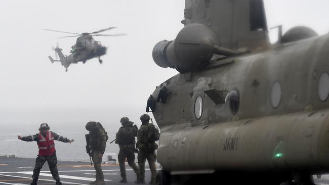 BEST PHOTOGRAPHS 2022. Evan Morgan. Exercise sea Explorer at Cowley Beach. Soldiers from 1st Battalion the Royal Australian Battalion (1RAR) disembark from a CH-47 Chinook on the flight deck of HMAS Adelaide. Picture: Evan Morgan