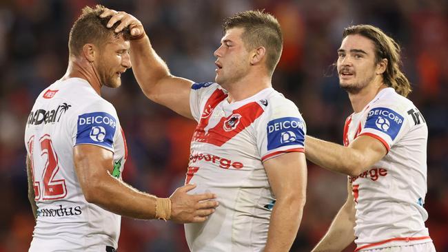 NEWCASTLE, AUSTRALIA - APRIL 04: Tariq Sims with Blake Lawrie and Cody Ramsey of St George celebrate the win during the round four NRL match between the Newcastle Knights and the St George Illawarra Dragons at McDonald Jones Stadium, on April 04, 2021, in Newcastle, Australia. (Photo by Ashley Feder/Getty Images)